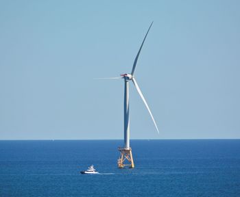 Sailboat on sea against clear sky