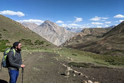 Man standing on mountain against sky