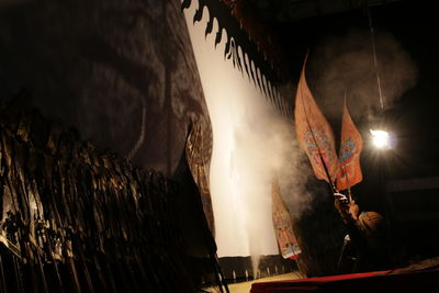 Low angle view of man holding flags