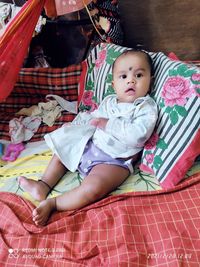 High angle view of cute baby relaxing at home