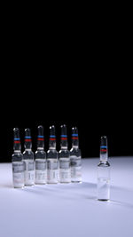 Close-up of bottles against black background