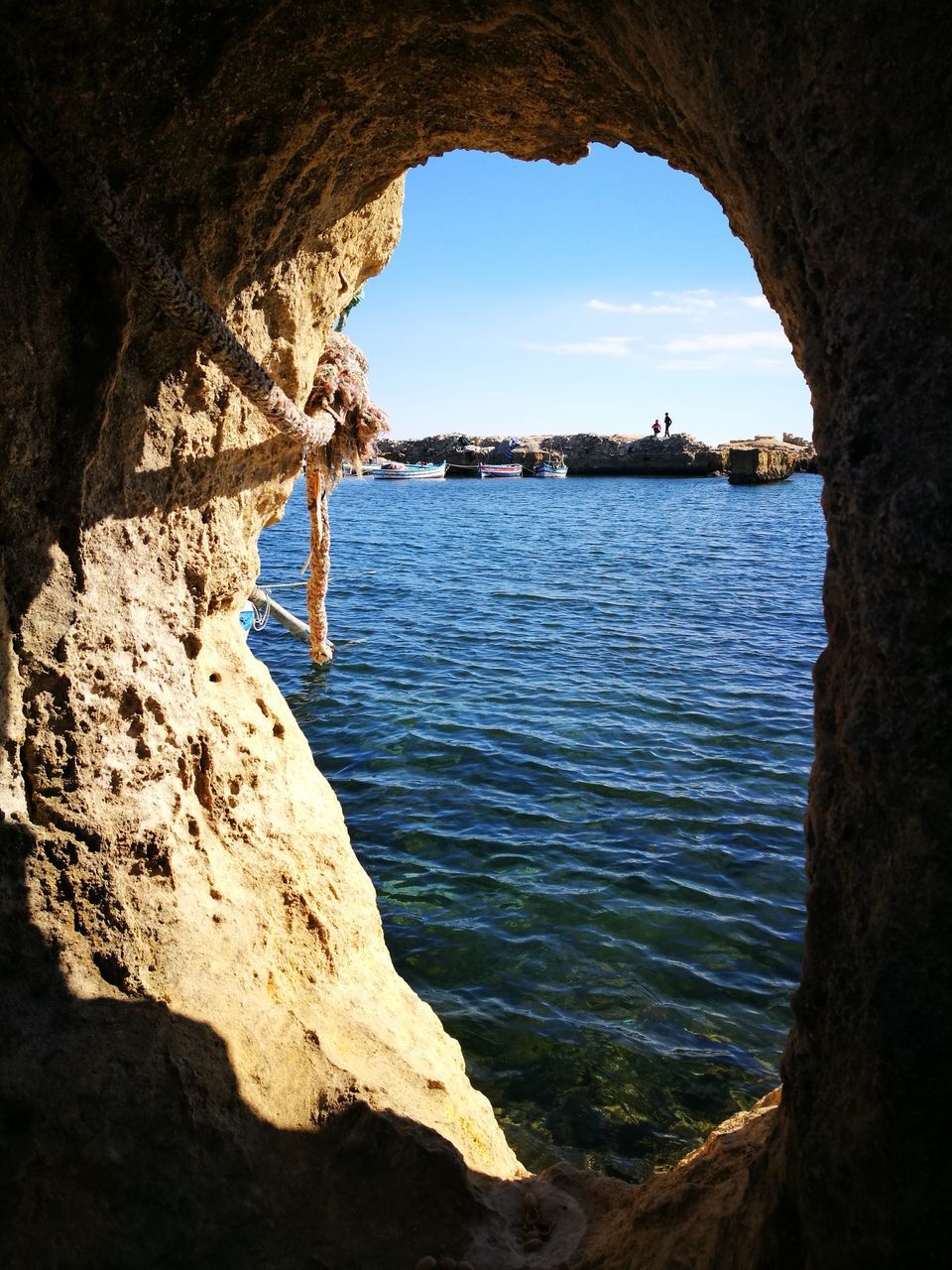 rock formation, natural arch, rock - object, arch, water, nature, day, beauty in nature, sea, no people, architecture, outdoors, built structure, scenics, sky