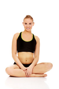 Portrait of smiling young woman against white background