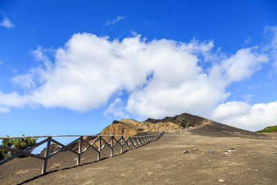 Scenic view of mountain against blue sky