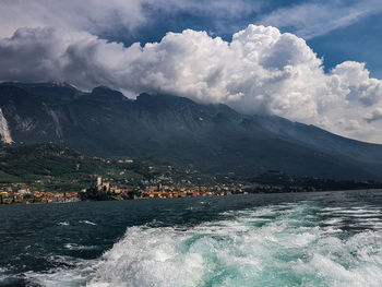 Scenic view of sea and mountains against sky