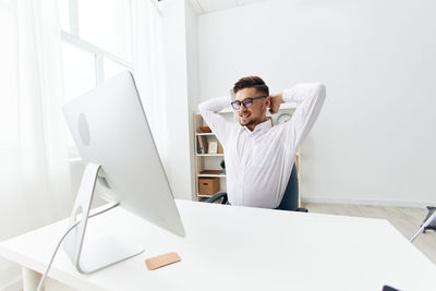 Young woman using mobile phone in office