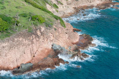 Rock formation in sea against sky