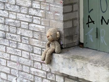 Close-up of child in stone wall