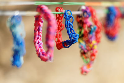 Close-up of colorful wristband hanging on string