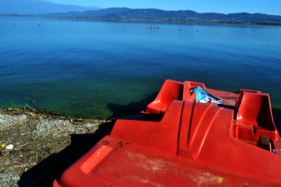 Pedal boat moored at lakeshore