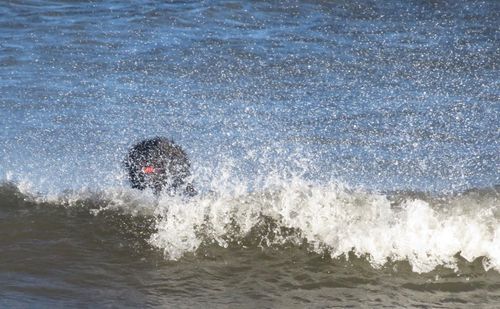 Man splashing water in sea