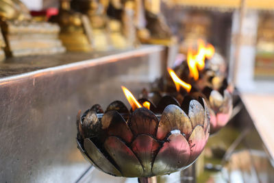 Close-up of burning candles in temple
