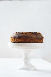 Close-up of bread on table against white background