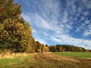 Scenic view of grassy field against cloudy sky