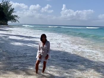 Full length of woman standing on beach