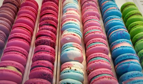 High angle view of multi colored macaroons for sale in shop
