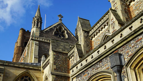 Low angle view of st albans cathedral against sky in city