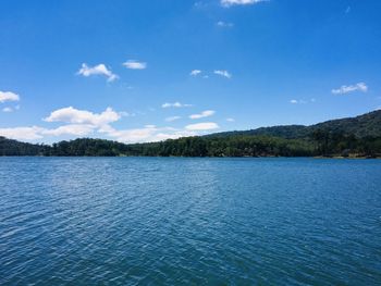 Scenic view of lake against blue sky