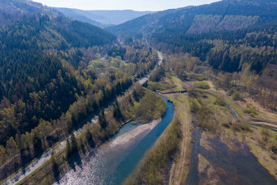 High angle view of road amidst trees and mountains