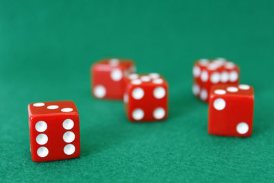 High angle view of dice on green table