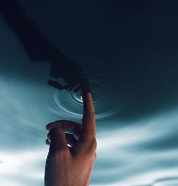 Midsection of person holding sea against sky