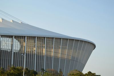 Low angle view of modern building against clear blue sky