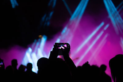 People photographing at music concert