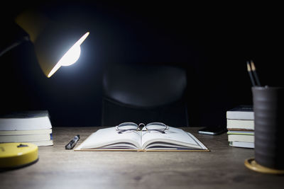 Close-up of illuminated lamp on table