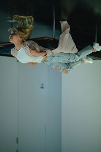 Upside down image of woman relaxing on seat