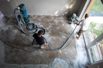 High angle view of men cleaning floor at home
