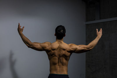 Rear view of shirtless muscular man