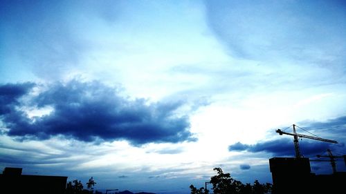 Low angle view of silhouette statue against sky