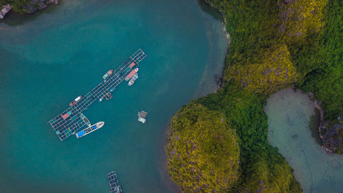 Aerial view of boat in sea by rock formation