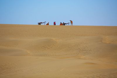 View of desert against clear blue sky