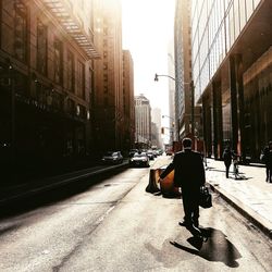 People walking on footpath in city