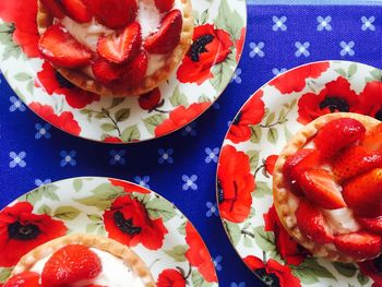 High angle view of strawberry tarts served on table