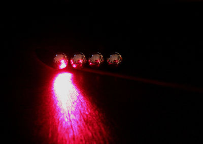 Close-up of light bulb over black background