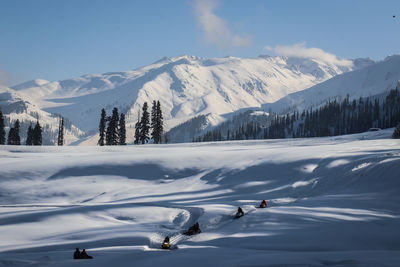 Scenic view of snowcapped mountains against sky