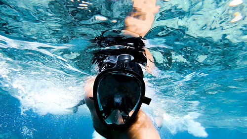 Midsection of person swimming in sea