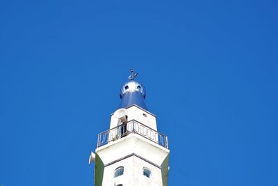 Low angle view of bell tower against blue sky