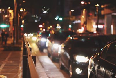 Cars on city street at night