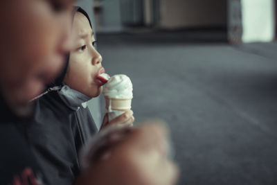 Close-up of young woman licking icecream