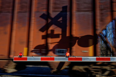 Shadow on railroad crossing sign on train