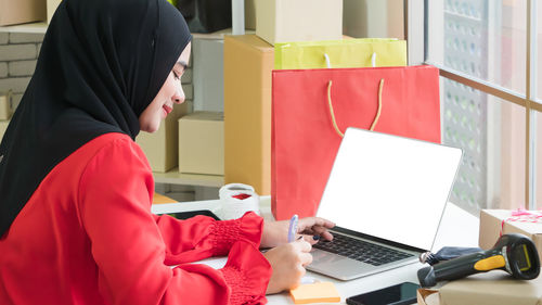 Side view of woman using mobile phone