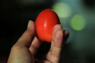 Close-up of hand holding strawberry