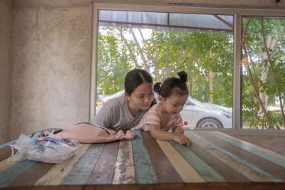 Women looking through window