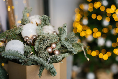 Christmas composition of fir branches, christmas balls and cotton bolls. selective focus. copy space