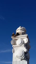 Low angle view of statue against blue sky
