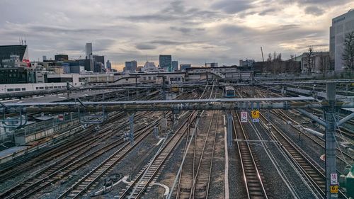 High angle view of railroad tracks amidst buildings in city