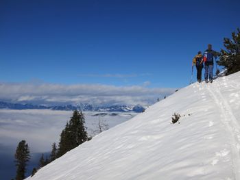 People walking on snow covered mountain